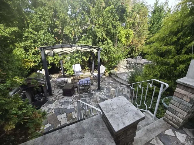 a view of a patio with table and chairs and potted plants