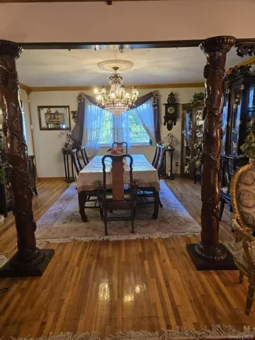 a view of a dining room with furniture and chandelier