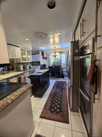 a kitchen with stainless steel appliances granite countertop a stove a sink dishwasher and a refrigerator