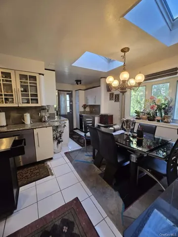 a kitchen with stainless steel appliances kitchen island granite countertop a sink dishwasher stove and cabinets