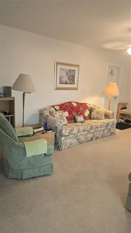 a living room with furniture and a lamp