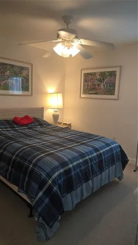 a bedroom with a bed and lamp