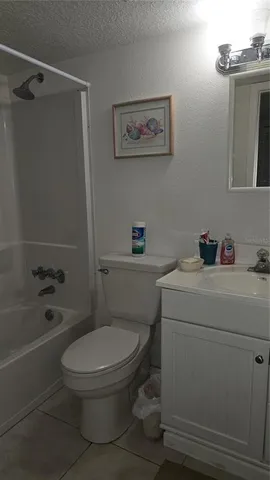a white toilet sitting next to a bath tub