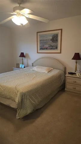a bedroom with a bed and a painting on the wall