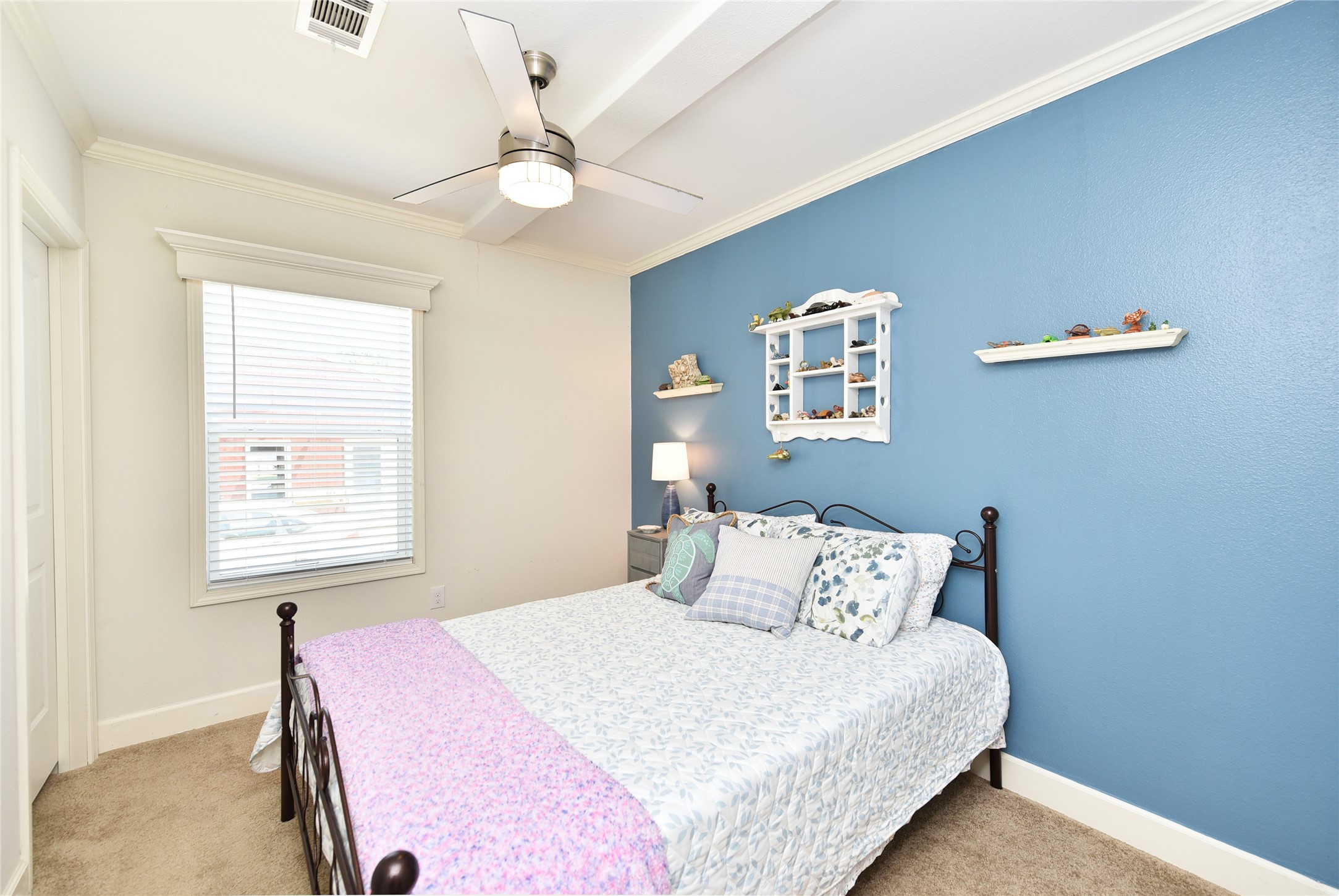 3221 Pecha Lane Rosenberg, TX 77471 - Photo 15 of 46 a bedroom with a large bed and a chandelier