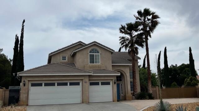 42107 Quail Run Way Lancaster, CA 93536 - Photo 1 of 38 a front view of a house with a yard and garage