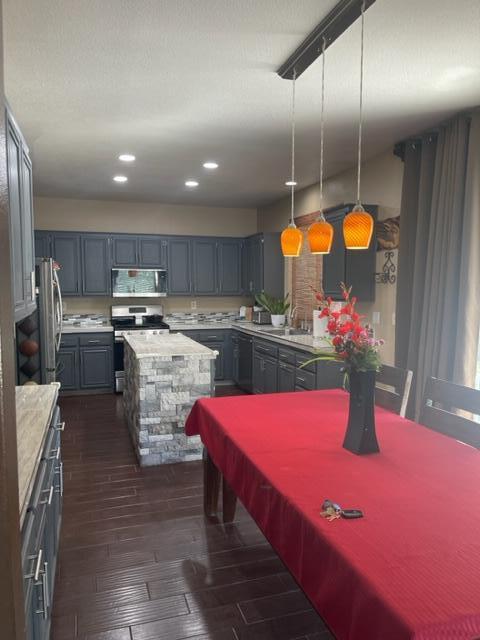 42107 Quail Run Way Lancaster, CA 93536 - Photo 12 of 38 a kitchen with stainless steel appliances granite countertop a sink dishwasher and cabinets with wooden floor