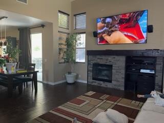 42107 Quail Run Way Lancaster, CA 93536 - Photo 15 of 38 a living room with furniture a flat screen tv and a fireplace