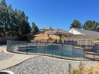 42107 Quail Run Way Lancaster, CA 93536 - Photo 20 of 38 a view of a white house that has a small yard and large trees