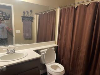 42107 Quail Run Way Lancaster, CA 93536 - Photo 32 of 38 a bathroom with a sink a toilet a mirror and shower curtain