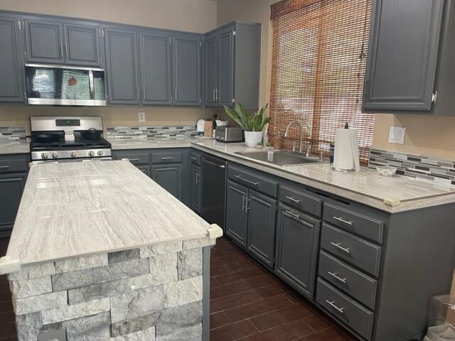 42107 Quail Run Way Lancaster, CA 93536 - Photo 10 of 38 a kitchen with a sink stove and cabinets