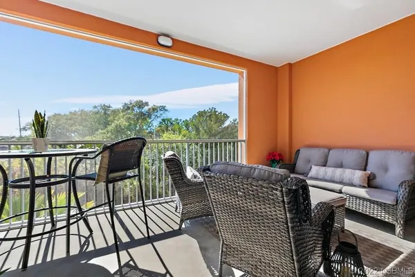 a view of a chairs and table in the balcony