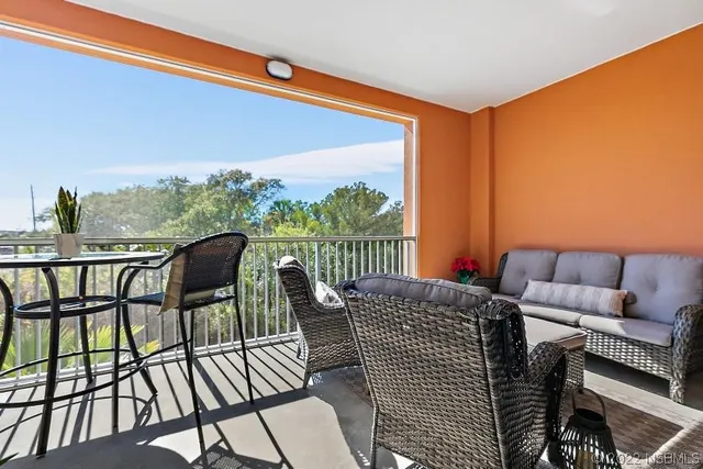 a view of a chairs and table in the balcony