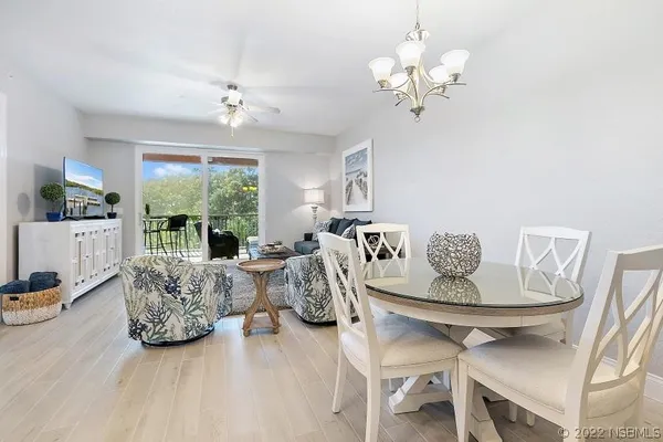 a living room with furniture a chandelier and a chandelier