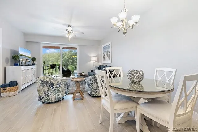 a living room with furniture a chandelier and a chandelier