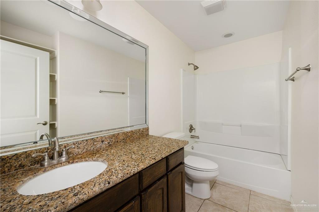 2302 North 26th Street Hidalgo, TX 78557 - Photo 12 of 19 a bathroom with a granite countertop sink toilet and shower