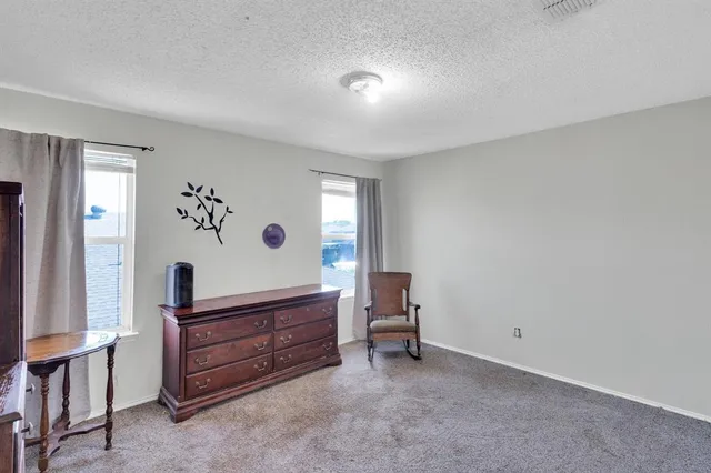 a spacious bedroom with a bed and a couch