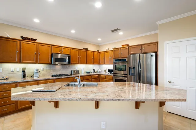 a kitchen with stainless steel appliances granite countertop a sink and cabinets