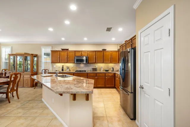 a view of a patio with table and chairs and potted plants