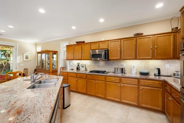 a spacious bathroom with a granite countertop sink a mirror and a
