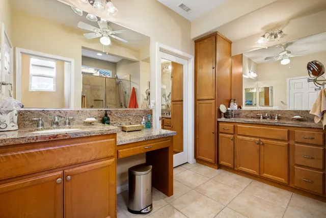 a view of a patio with couches table and chairs and potted plants