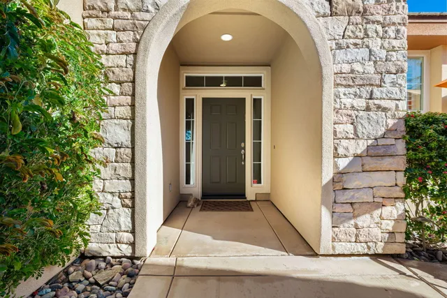 a blue living room with furniture and a large window