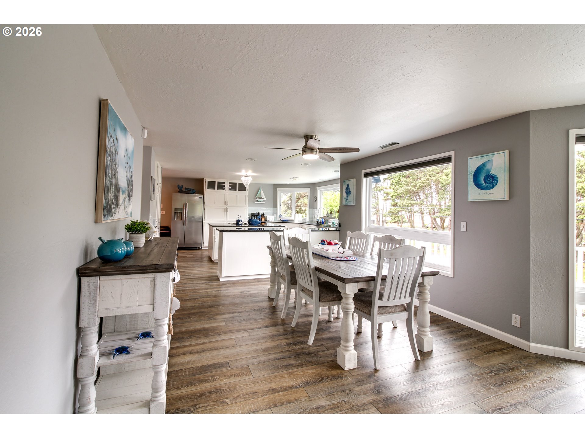 3085 Beach Loop Drive Southwest Bandon, OR 97411 - Photo 11 of 46 a view of a dining room with furniture and wooden floor