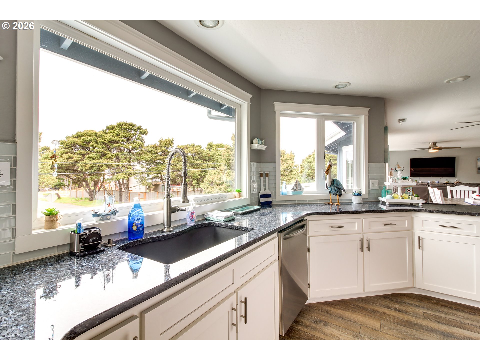 3085 Beach Loop Drive Southwest Bandon, OR 97411 - Photo 12 of 46 a kitchen with a sink a counter top space appliances and a window