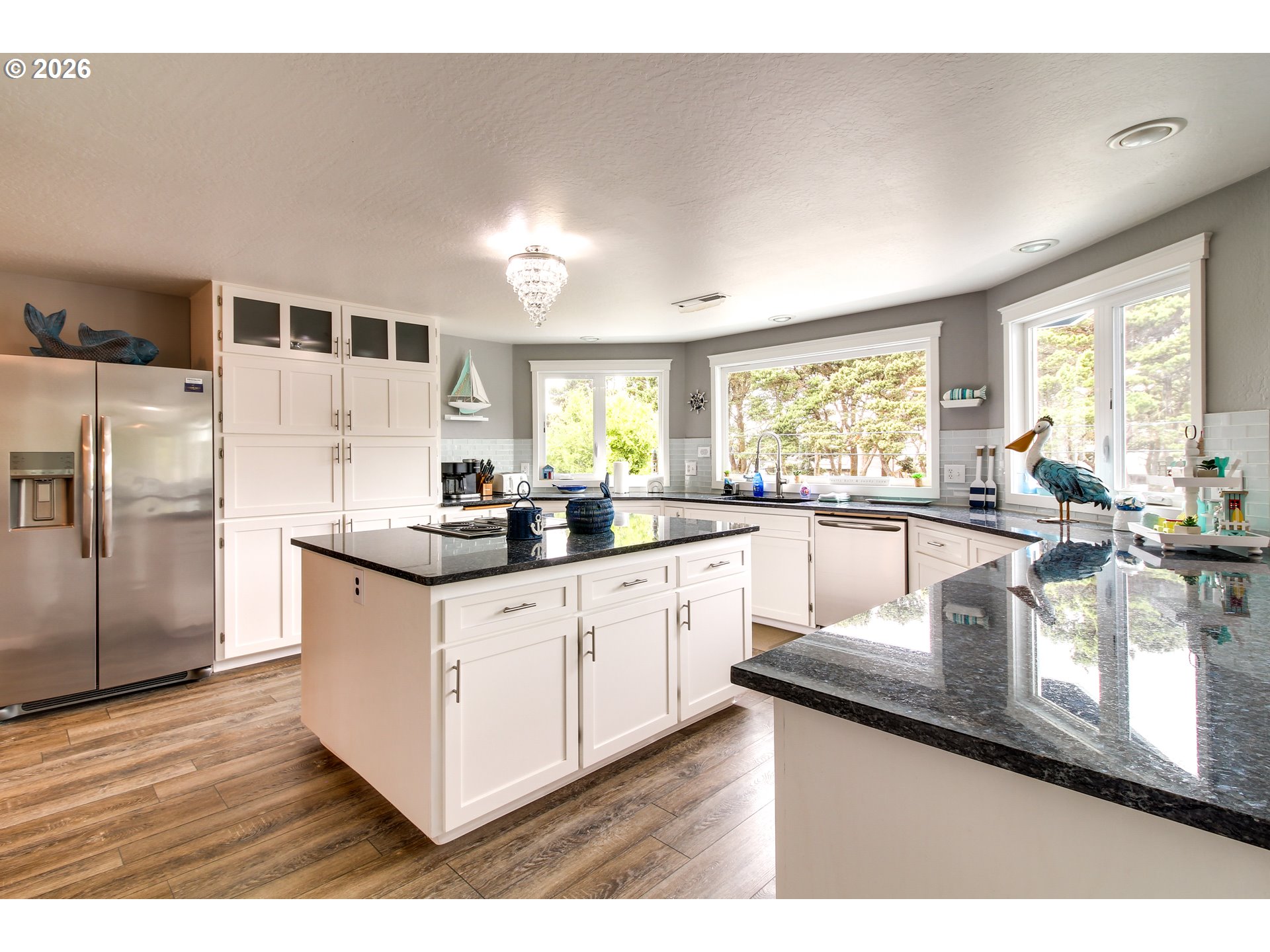 3085 Beach Loop Drive Southwest Bandon, OR 97411 - Photo 14 of 46 a kitchen with stainless steel appliances granite countertop a sink stove and refrigerator