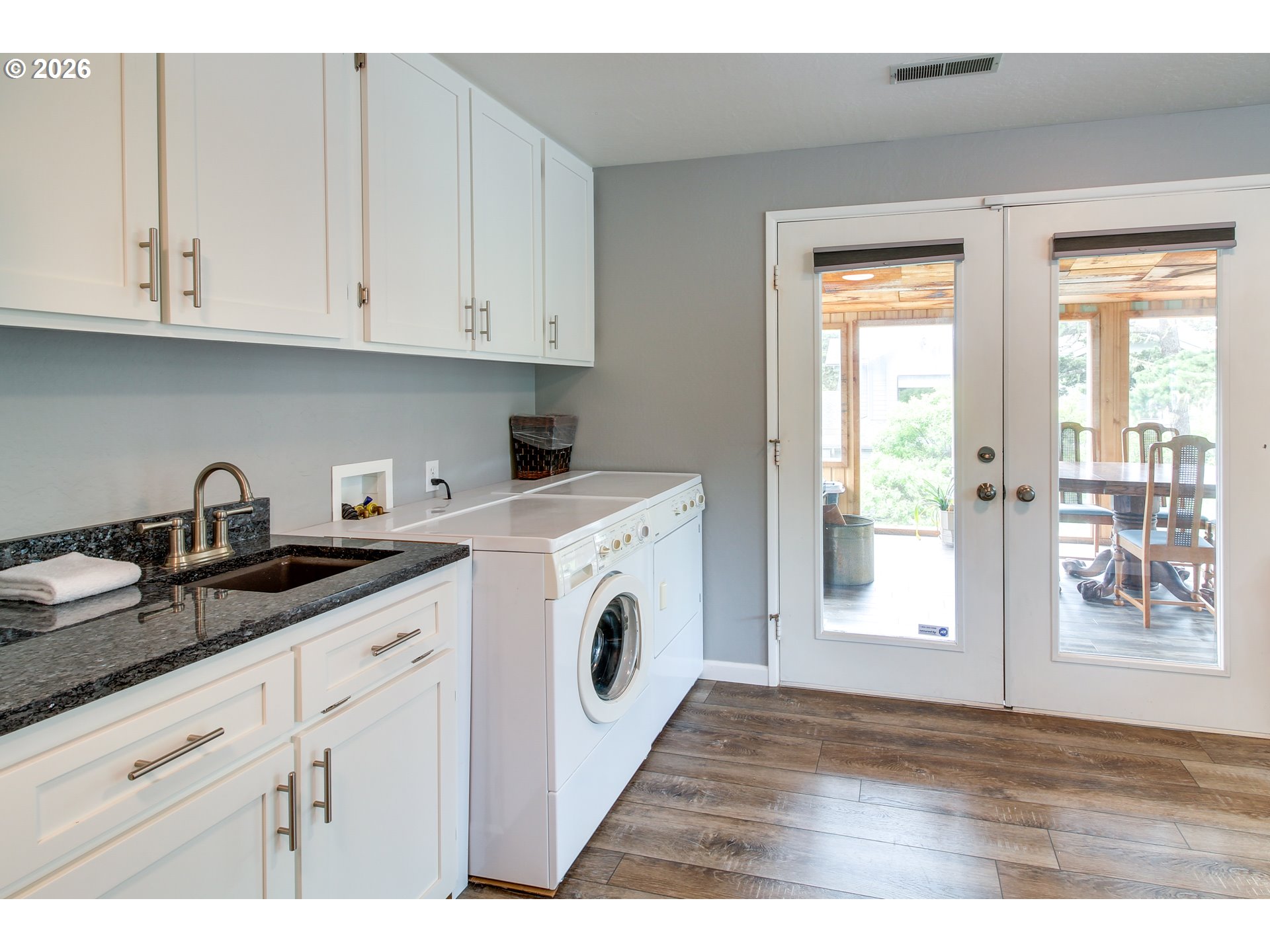 3085 Beach Loop Drive Southwest Bandon, OR 97411 - Photo 17 of 46 a kitchen with granite countertop white cabinets and white appliances