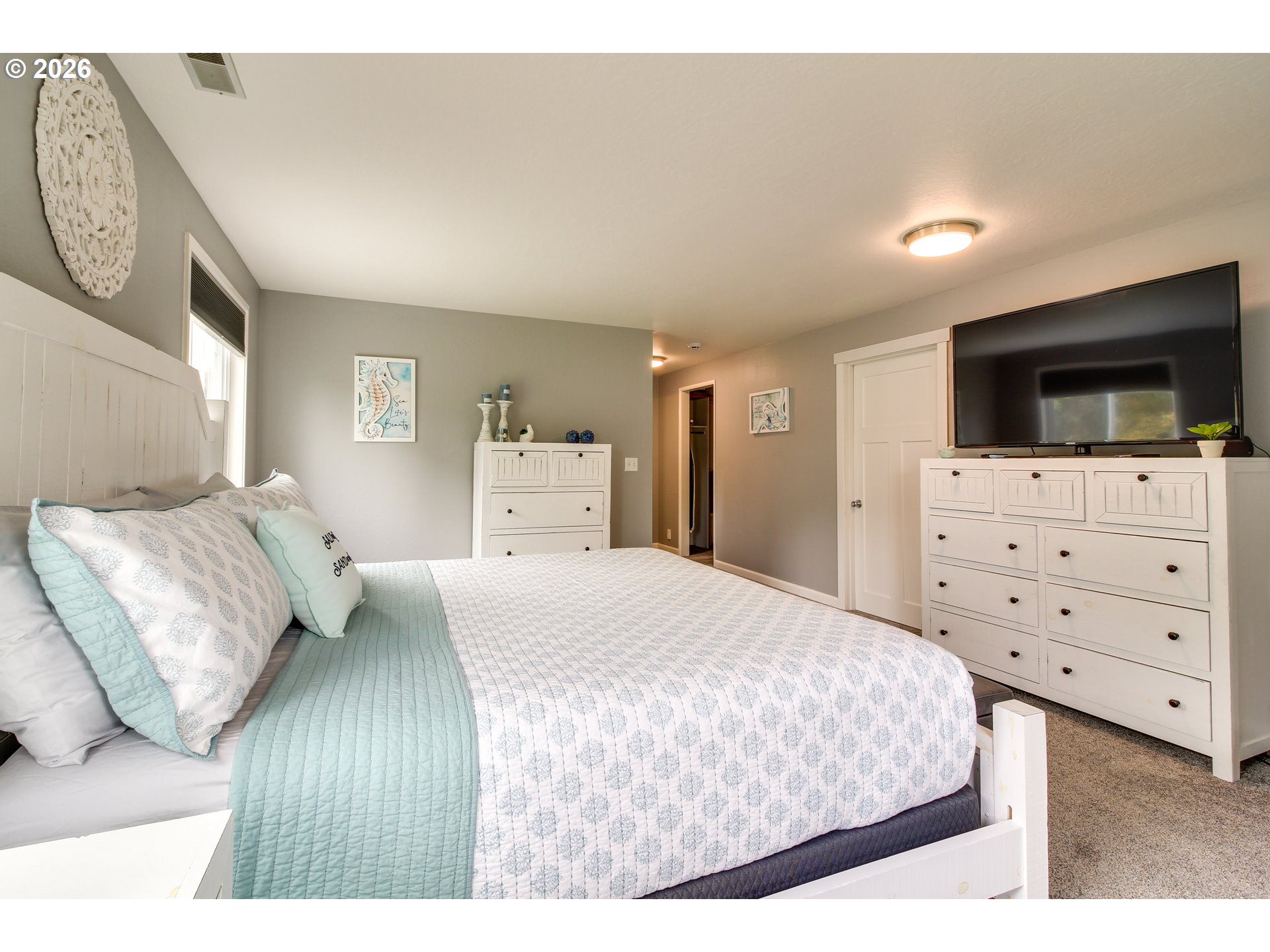 3085 Beach Loop Drive Southwest Bandon, OR 97411 - Photo 20 of 46 a bedroom with a bed and a flat screen tv