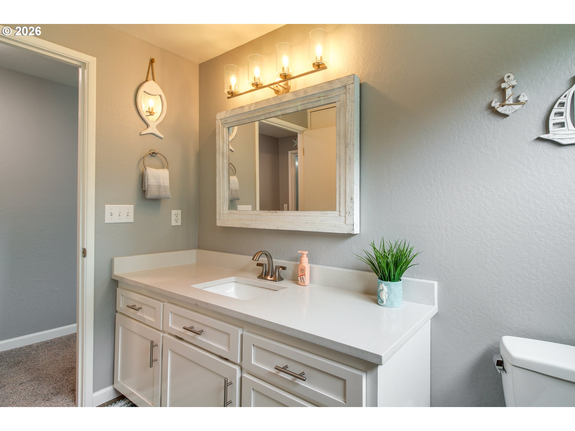 3085 Beach Loop Drive Southwest Bandon, OR 97411 - Photo 22 of 46 a bathroom with a sink vanity and a mirror