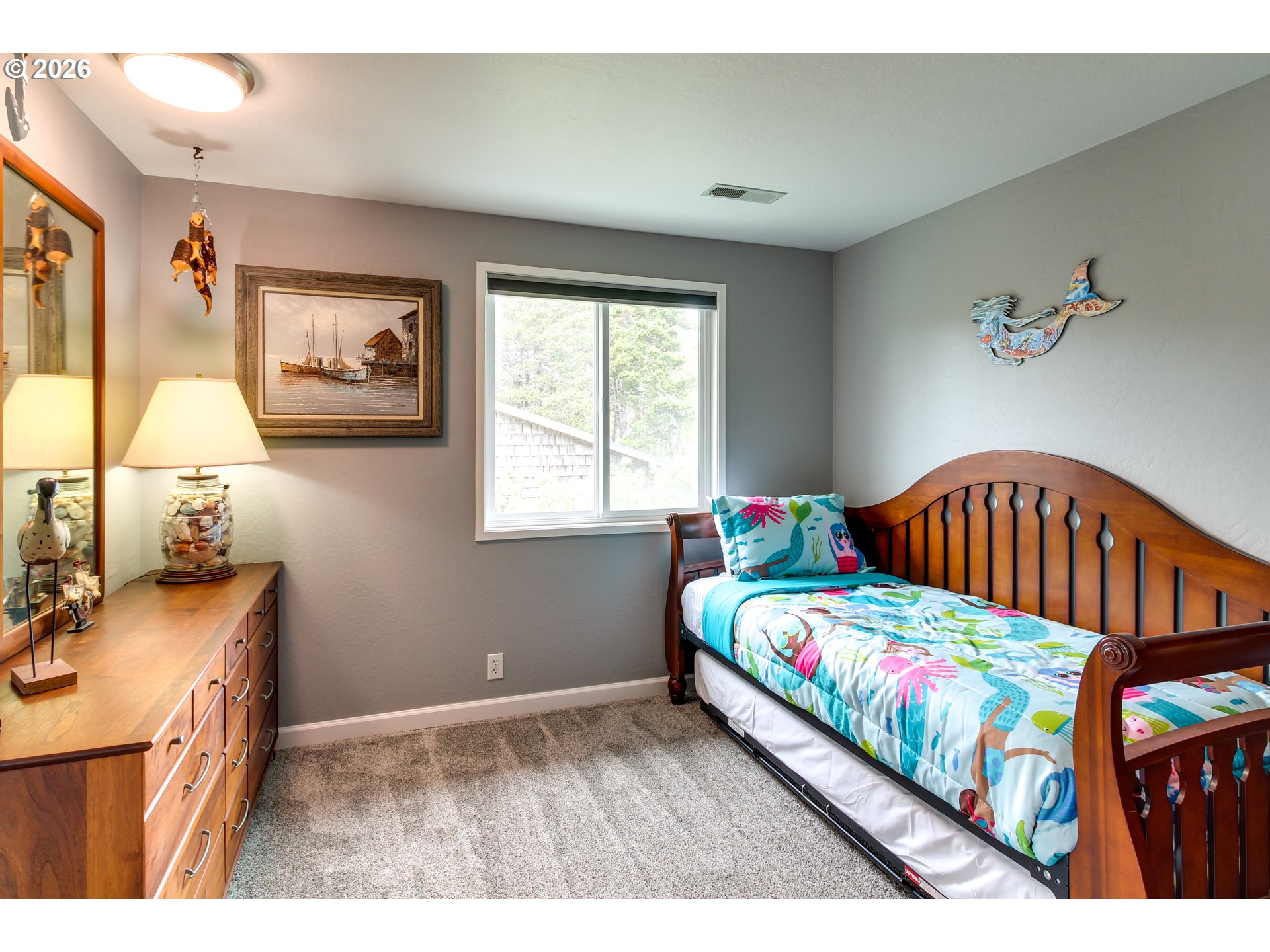 3085 Beach Loop Drive Southwest Bandon, OR 97411 - Photo 27 of 46 a bedroom with a bed next to a window