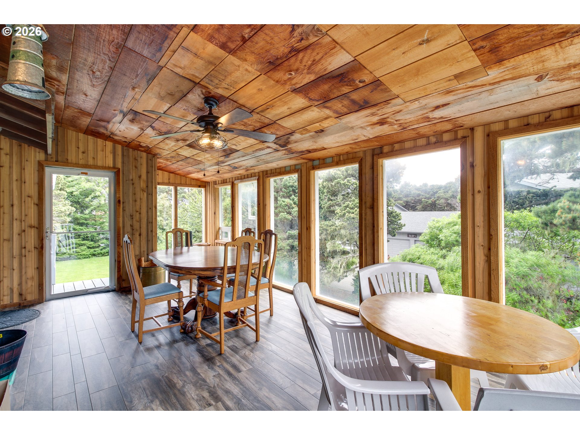 3085 Beach Loop Drive Southwest Bandon, OR 97411 - Photo 30 of 46 a dining room with wooden floor and large windows