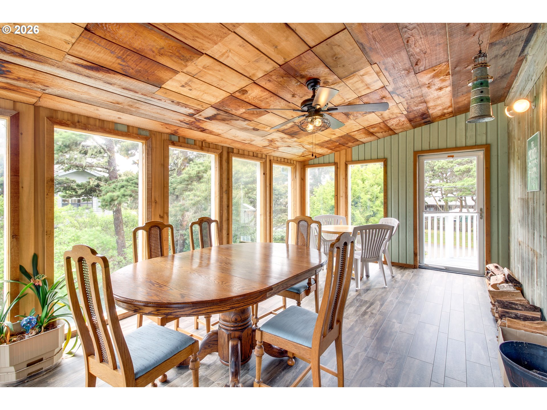 3085 Beach Loop Drive Southwest Bandon, OR 97411 - Photo 31 of 46 a dining room with furniture a chandelier and wooden floor