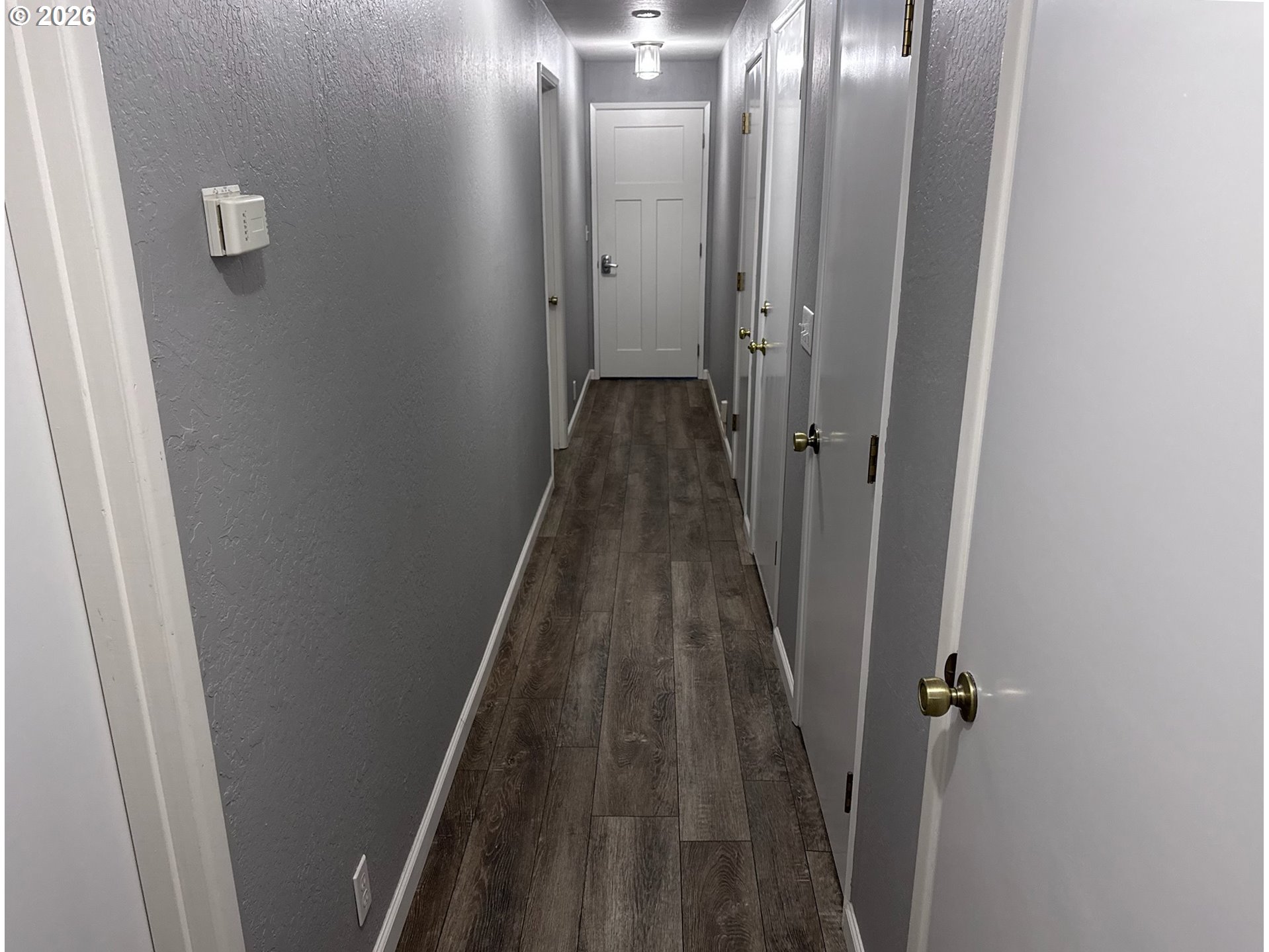 3085 Beach Loop Drive Southwest Bandon, OR 97411 - Photo 32 of 46 a view of a hallway with wooden floor