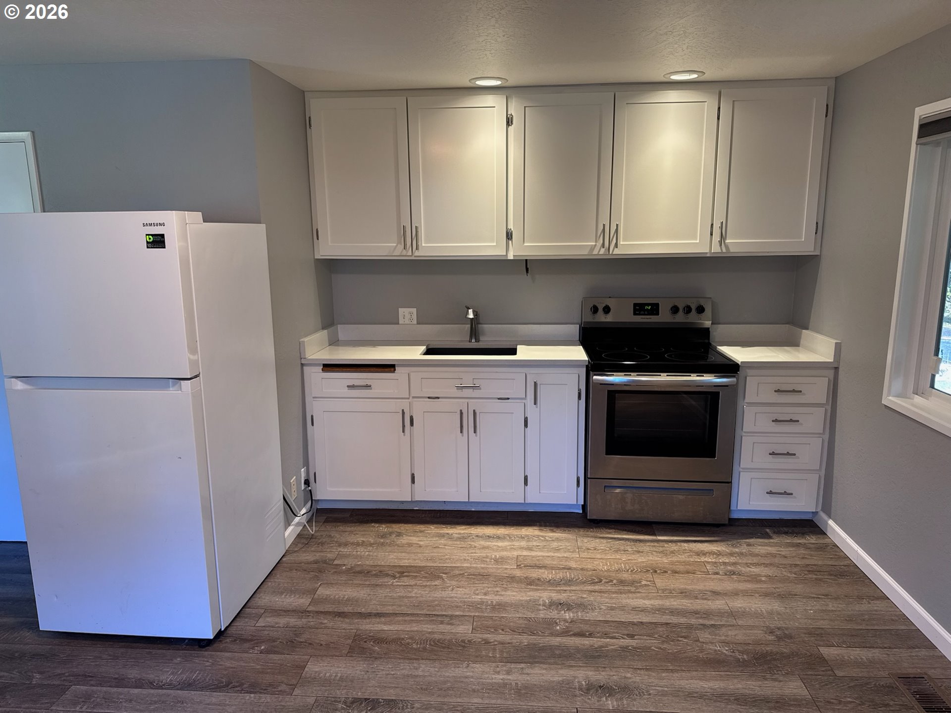 3085 Beach Loop Drive Southwest Bandon, OR 97411 - Photo 33 of 46 a kitchen with a white stove top oven and refrigerator