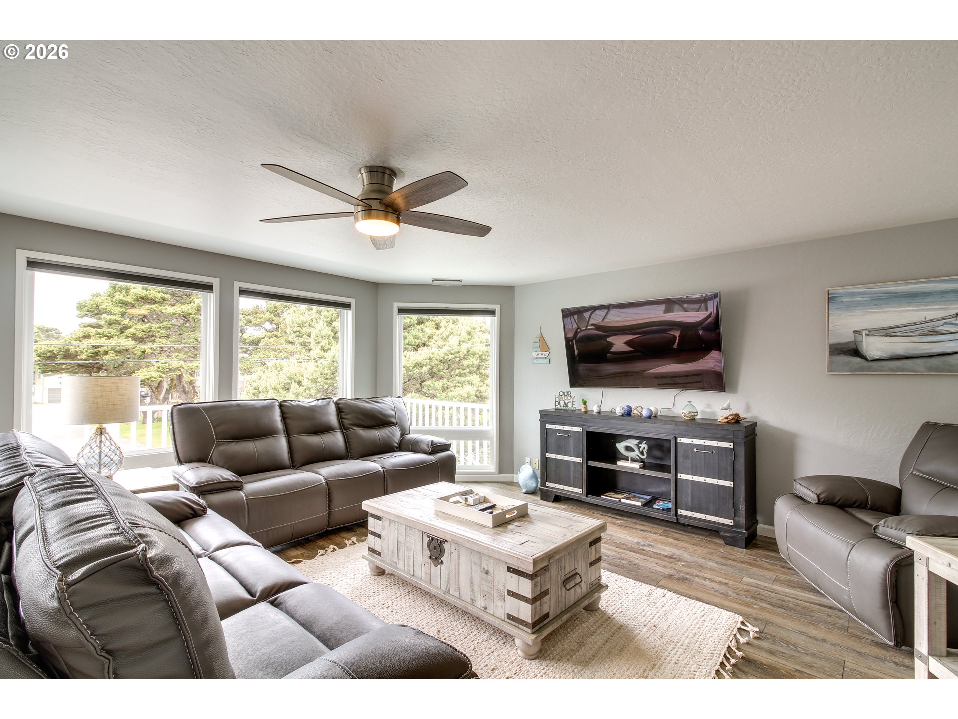 3085 Beach Loop Drive Southwest Bandon, OR 97411 - Photo 8 of 46 a living room with furniture flat screen tv and windows