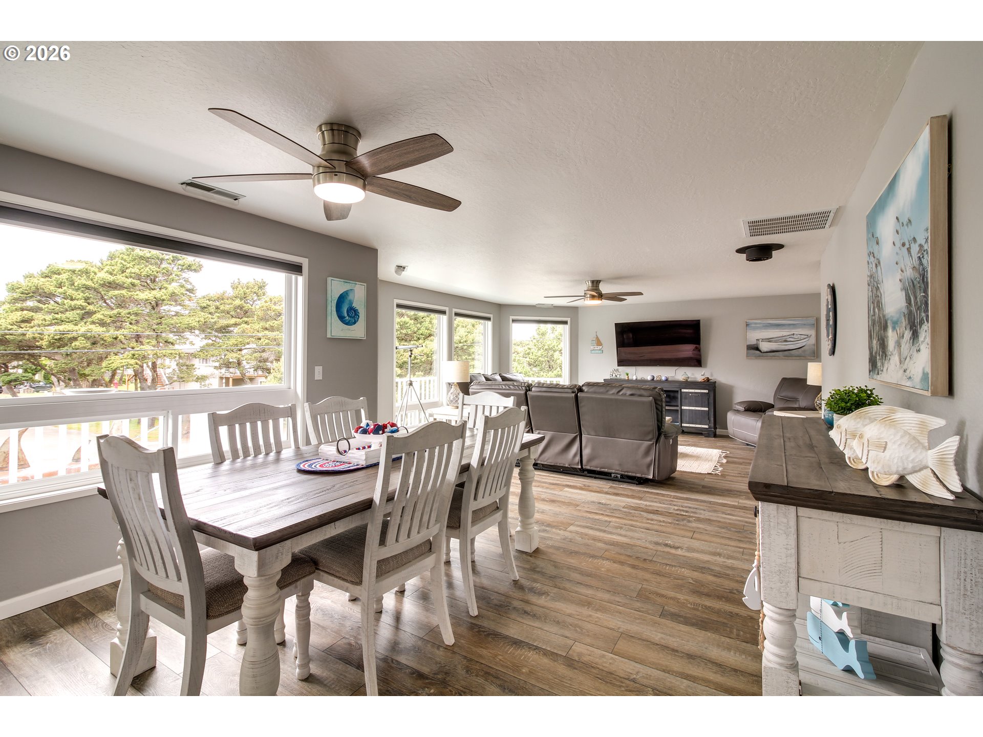3085 Beach Loop Drive Southwest Bandon, OR 97411 - Photo 10 of 46 a dining room with furniture a flat screen tv and a large window