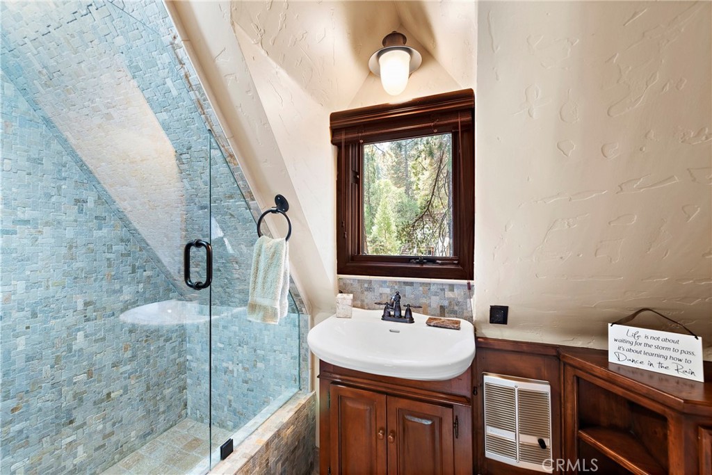 400 Cottage Grove Road Lake Arrowhead, CA 92352 - Photo 42 of 75 a bathroom with a sink a mirror and shower