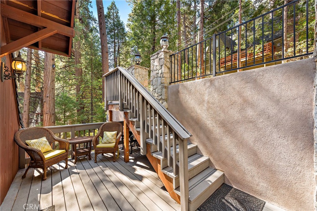 400 Cottage Grove Road Lake Arrowhead, CA 92352 - Photo 49 of 75 a view of balcony with chairs and wooden fence