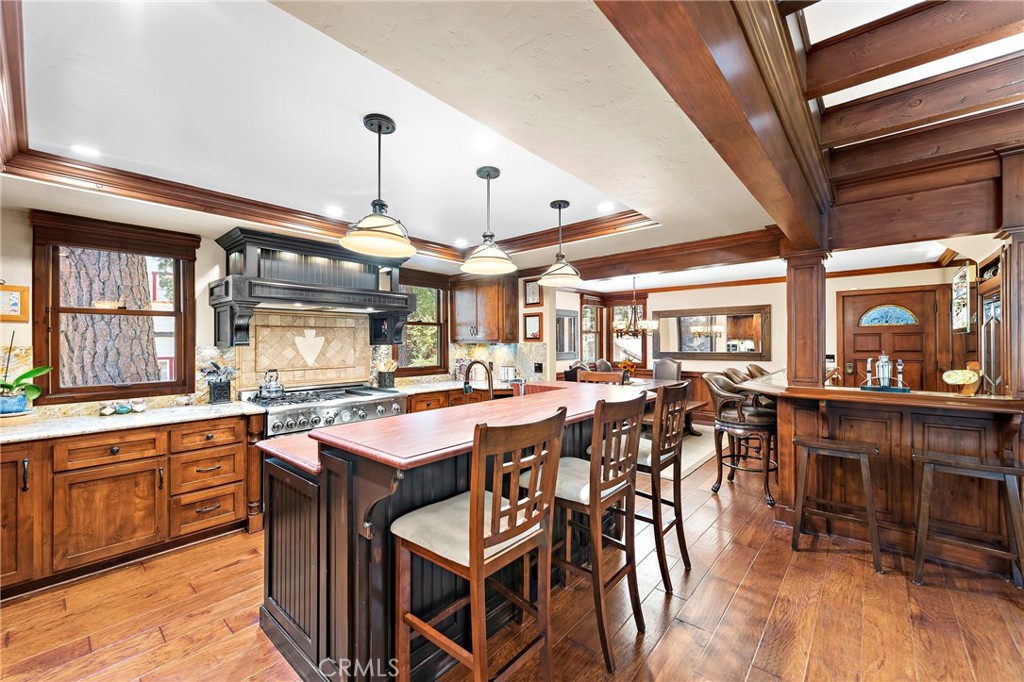 400 Cottage Grove Road Lake Arrowhead, CA 92352 - Photo 8 of 75 a dining hall with stainless steel appliances kitchen island granite countertop a table chairs and a chandelier