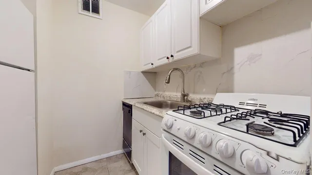 a kitchen with a stove and a sink