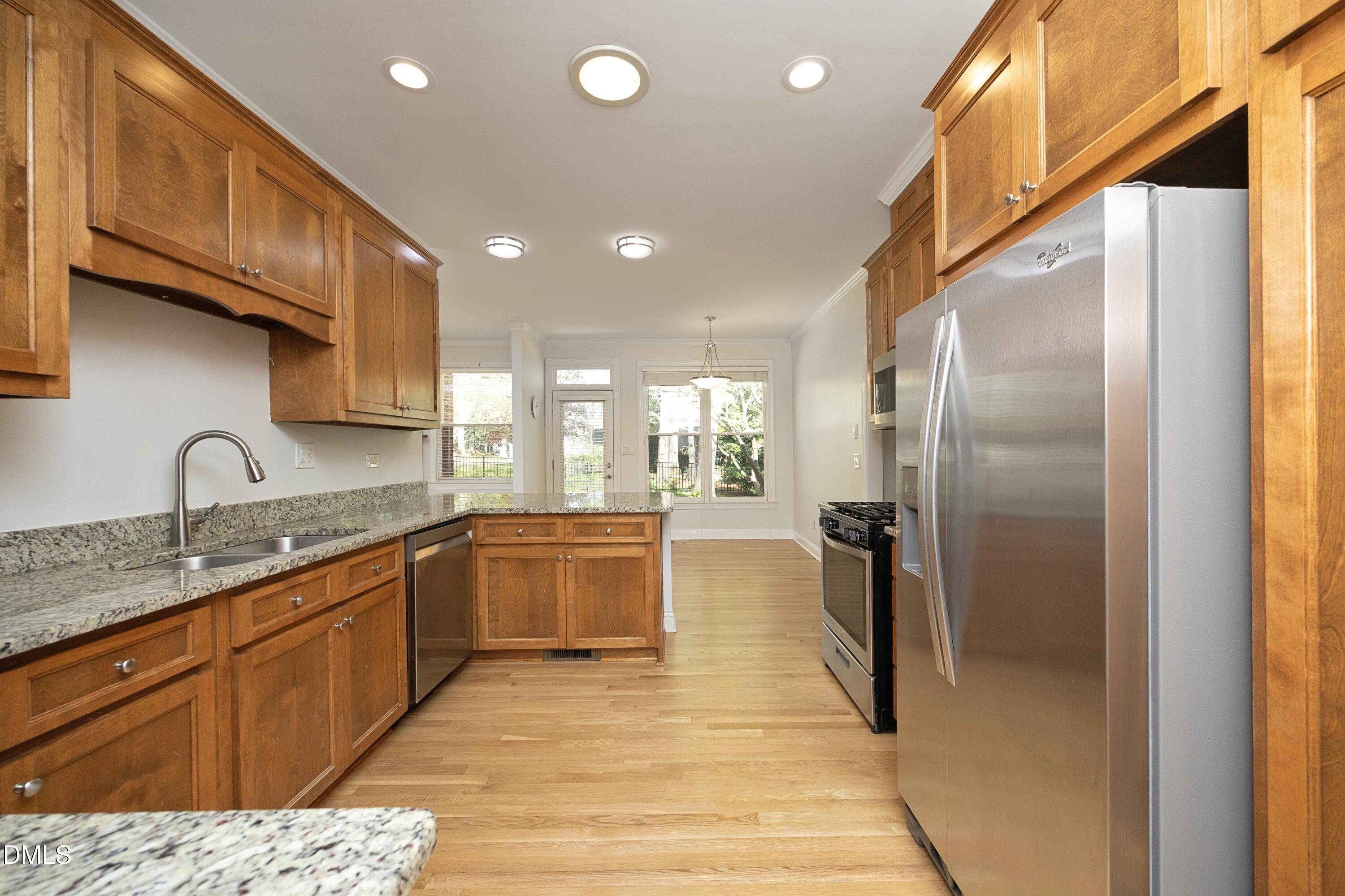 1427 Moosecreek Drive Raleigh, NC 27614 - Photo 15 of 48 a large kitchen with stainless steel appliances granite countertop a refrigerator a sink and a stove
