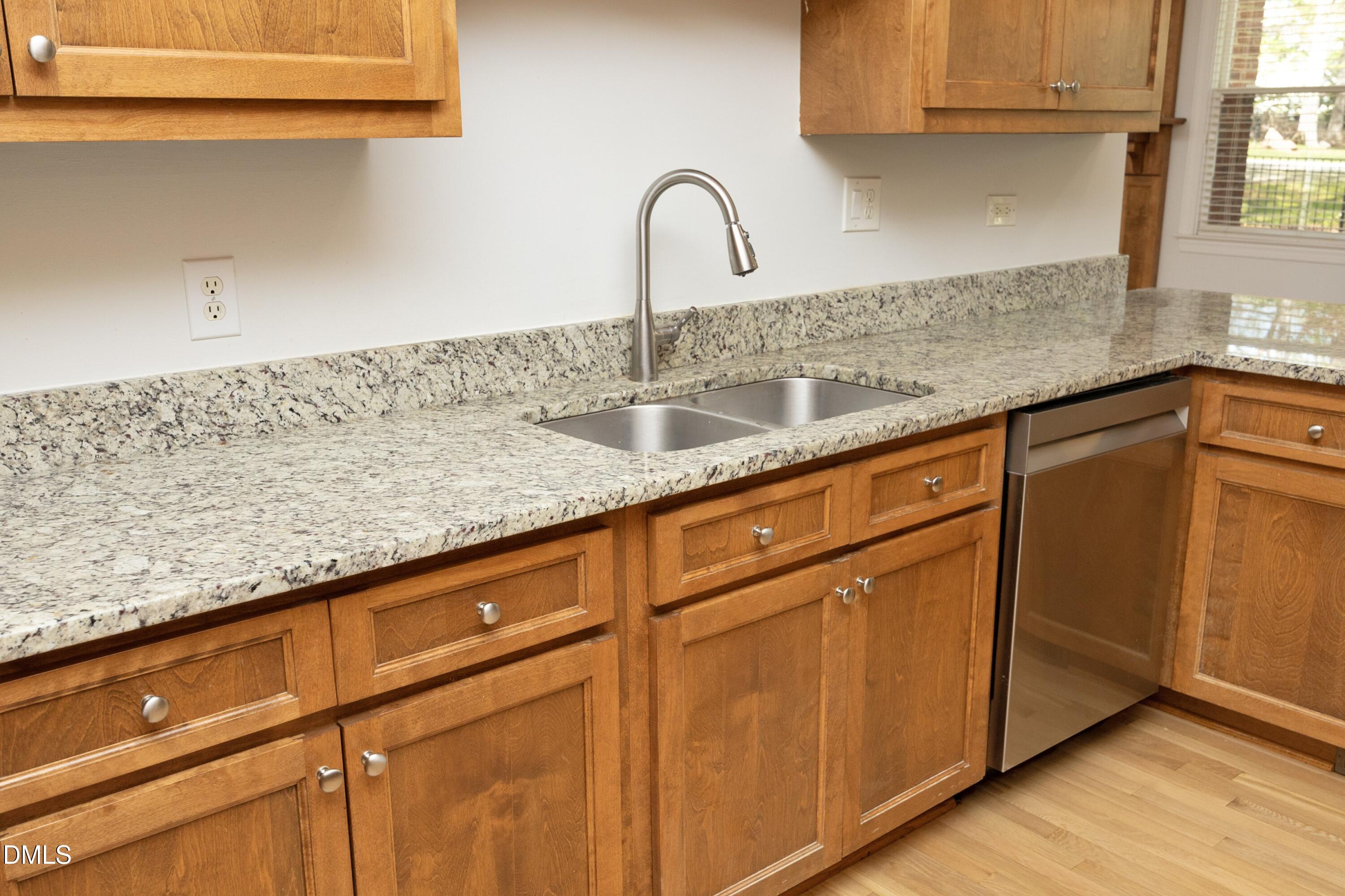 1427 Moosecreek Drive Raleigh, NC 27614 - Photo 17 of 48 a kitchen with granite countertop white cabinets and sink