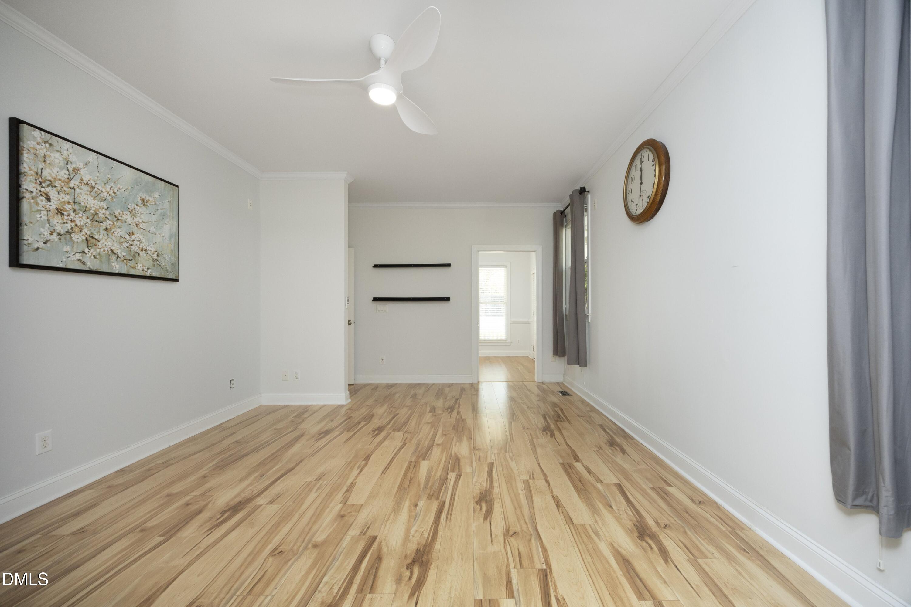 1427 Moosecreek Drive Raleigh, NC 27614 - Photo 21 of 48 a view of a room with wooden floor and white walls