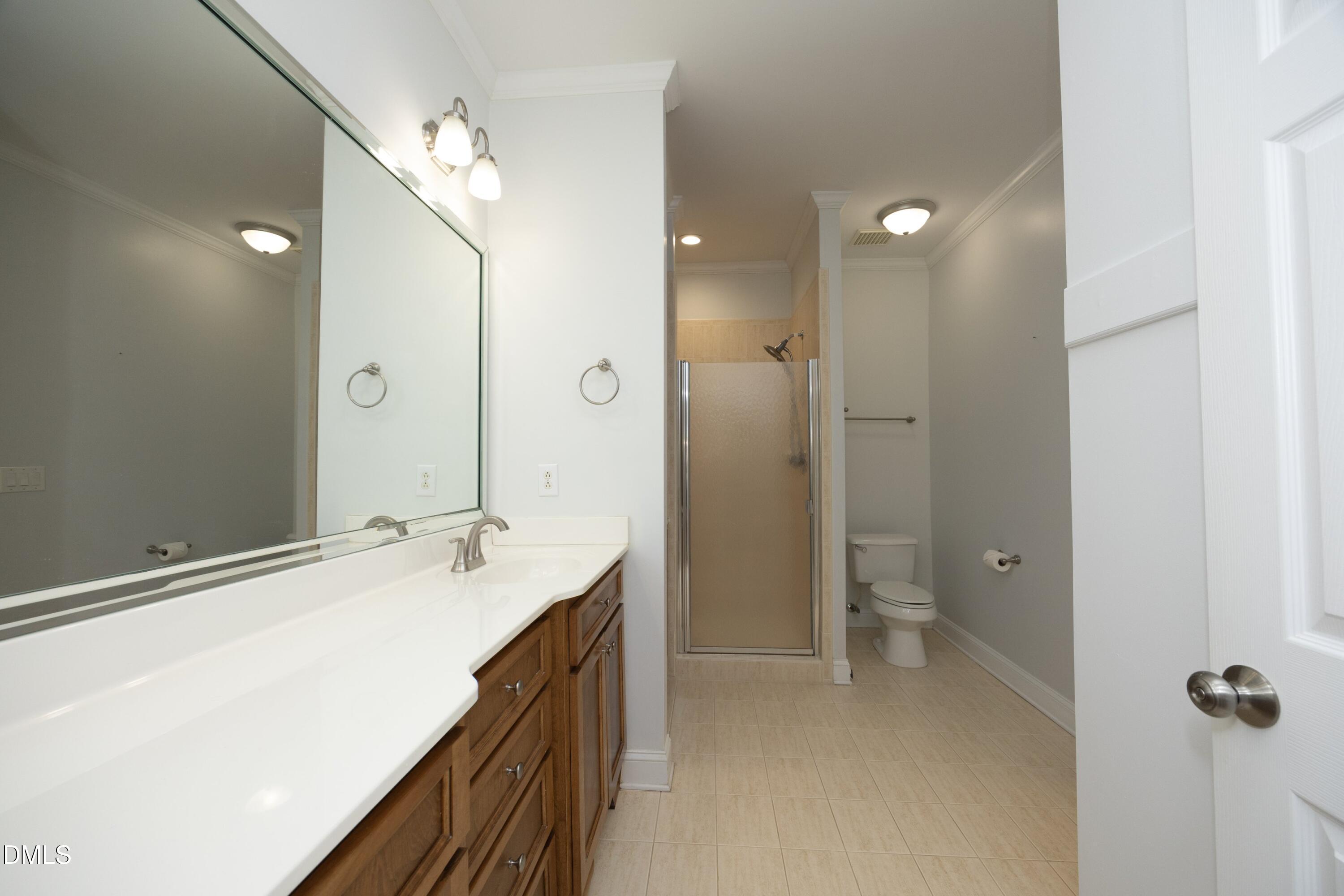 1427 Moosecreek Drive Raleigh, NC 27614 - Photo 23 of 48 a spacious bathroom with a shower sink and mirror
