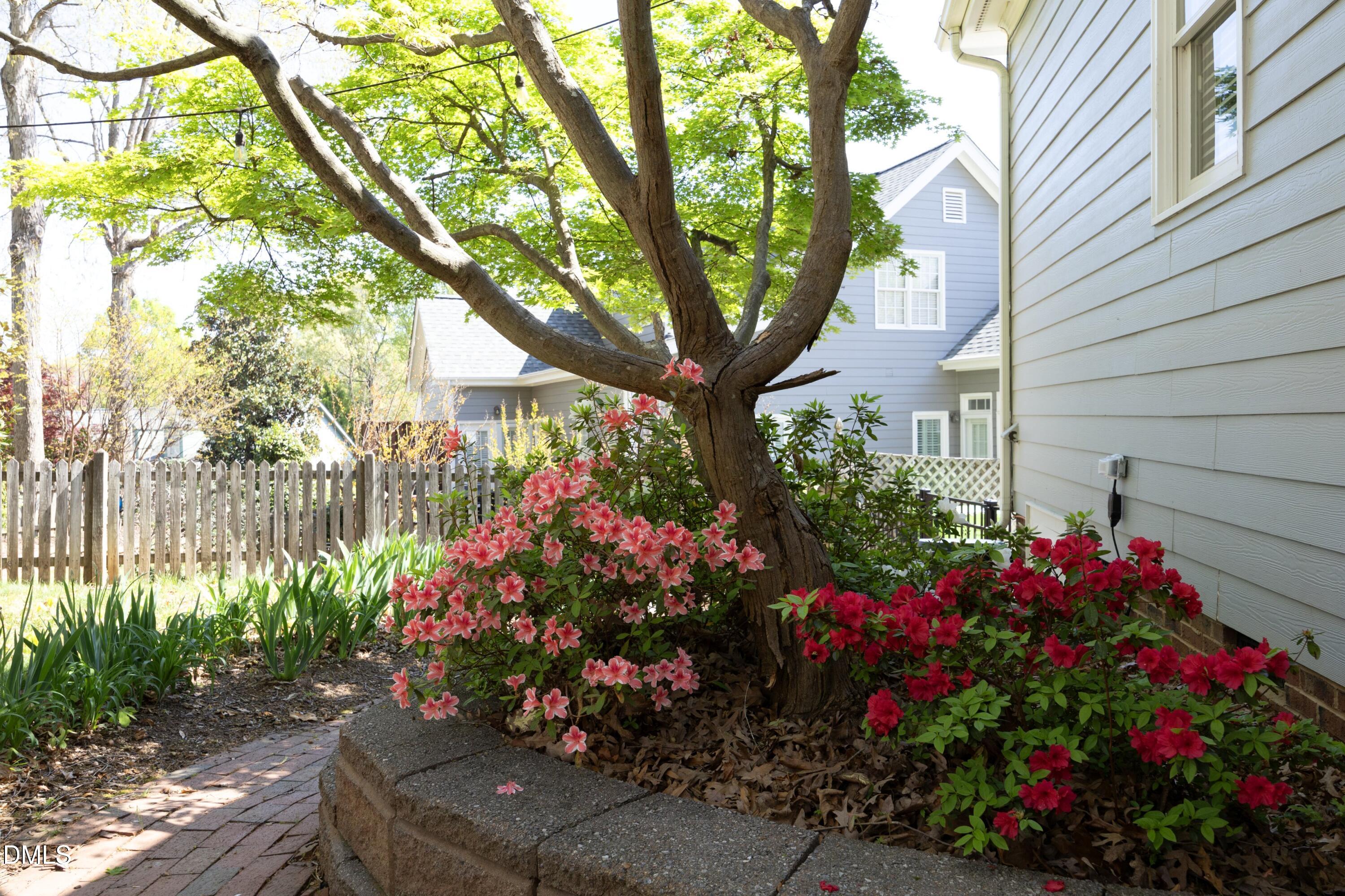 1427 Moosecreek Drive Raleigh, NC 27614 - Photo 38 of 48 a view of a wooden house with a flower garden