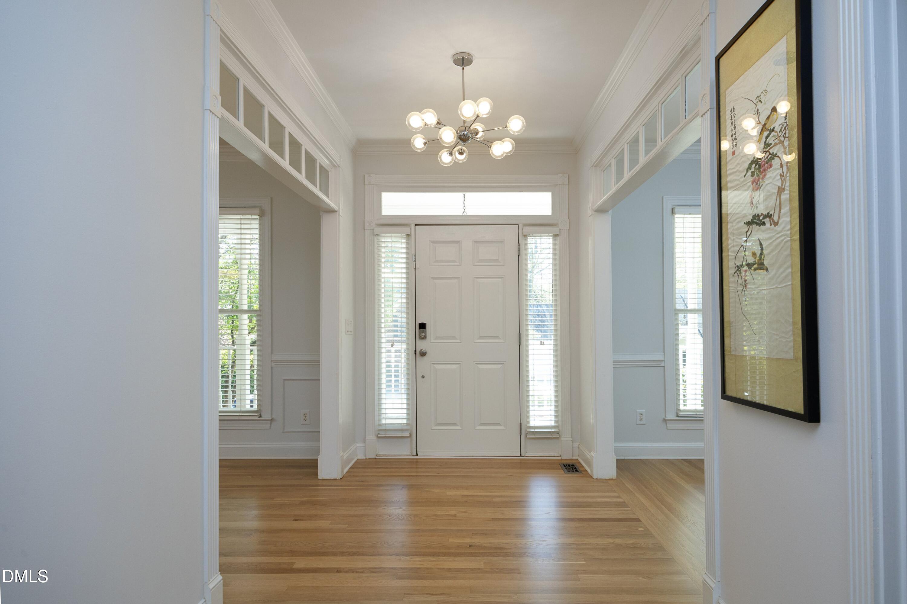 1427 Moosecreek Drive Raleigh, NC 27614 - Photo 7 of 48 a view of an empty room with window and wooden floor