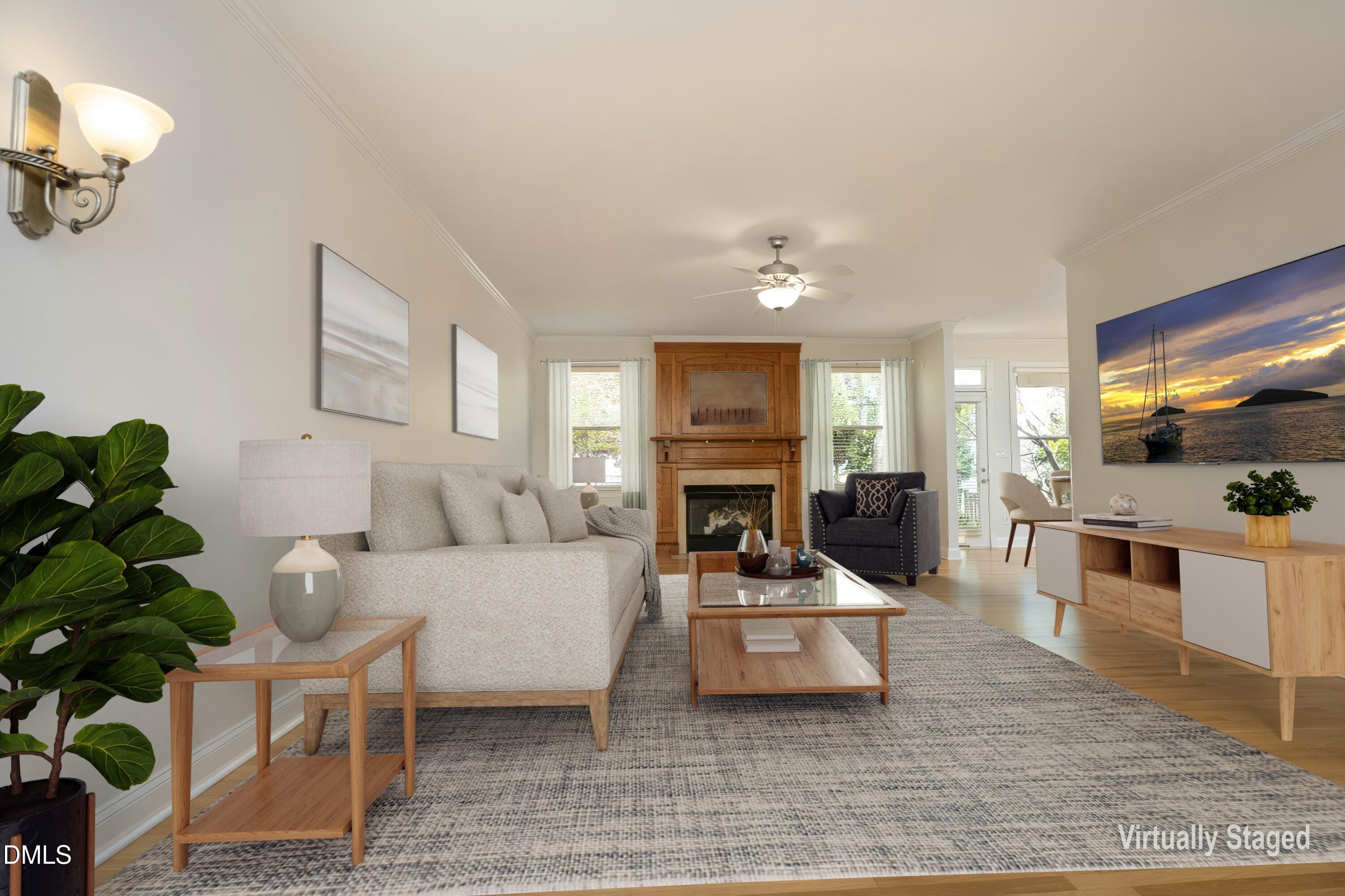 1427 Moosecreek Drive Raleigh, NC 27614 - Photo 8 of 48 a living room with furniture a fireplace a flat screen tv and kitchen view